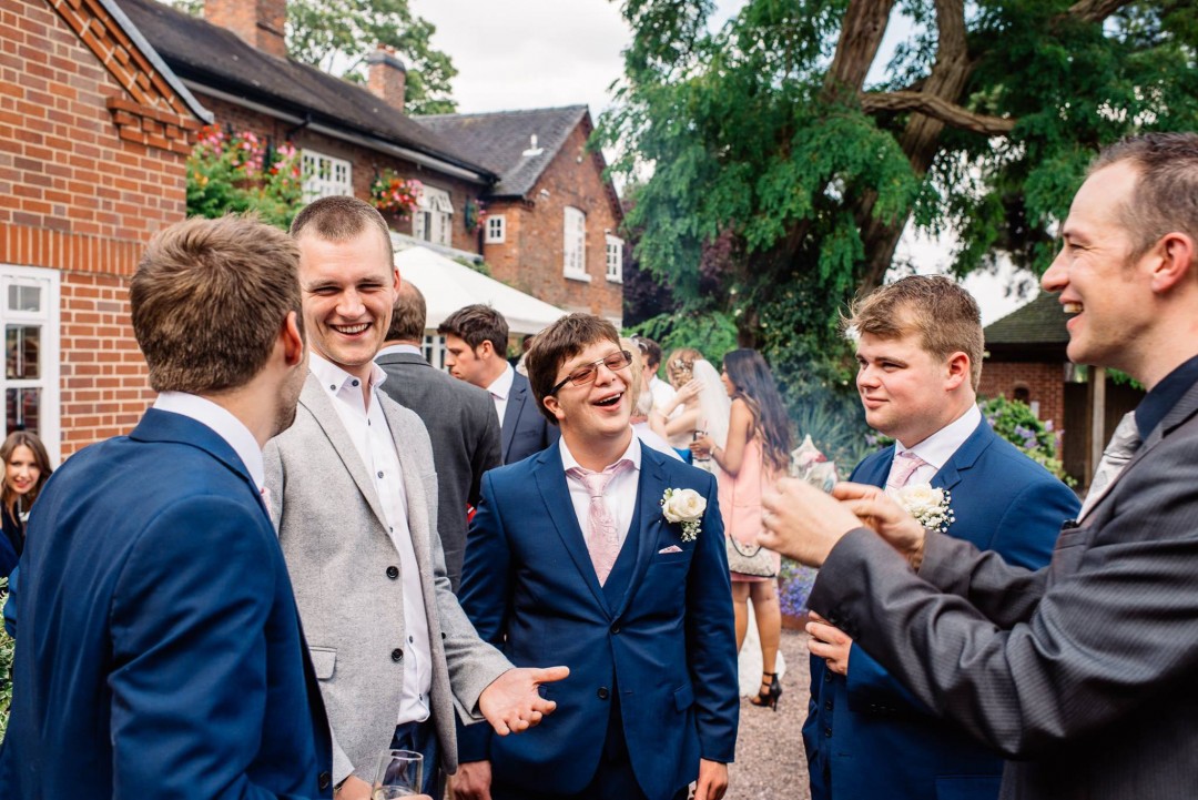 Groom and groomsmen amazed at outdoor wedding magic